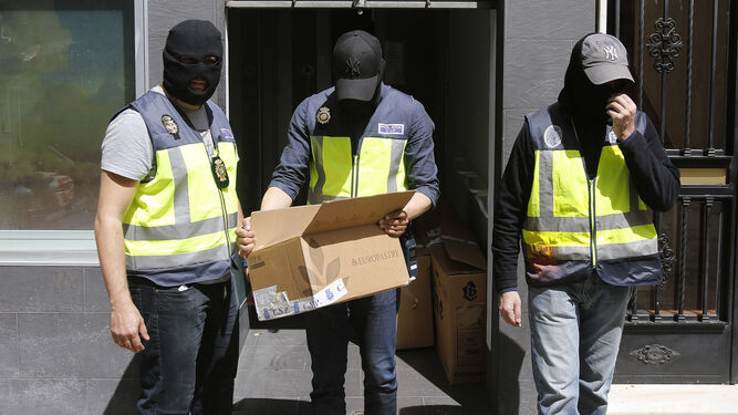 Los agentes se llevan material durante el registro del inmueble.