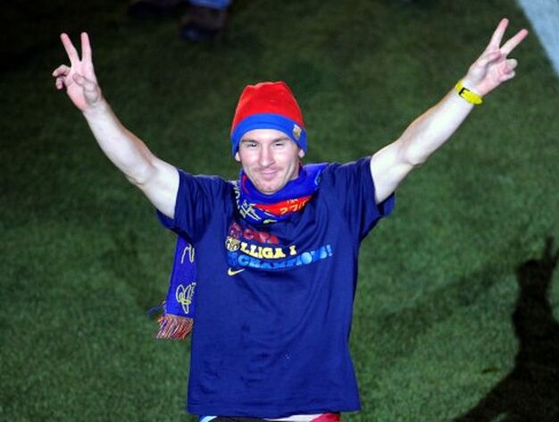 Leo Messi alza los brazos victorioso hacia la grada tras hablarles con el micr&oacute;fono.