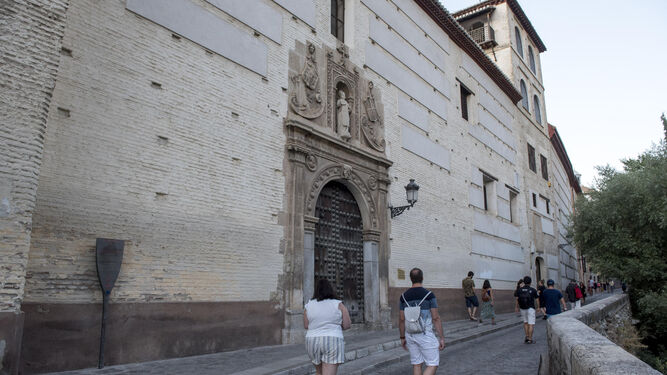 Varios turistas pasean frente a la fachada del convento de Santa Catalina de Zafra, situado junto al río Darro.