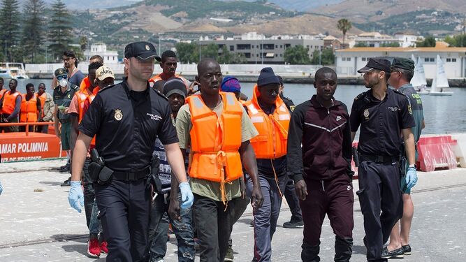 Agentes de la Policía Nacional prestan servicio a un grupo de inmigrantes rescatados y trasladados a Motril