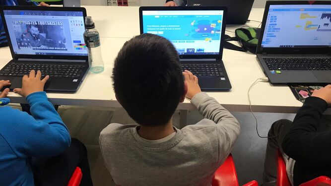 Niños manejando el ordenador en un taller para alta capacidad.