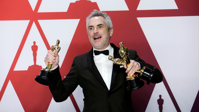 Alfonso Cuarón posa con las tres estatuillas de 'Roma' en la última edición de los Oscar.