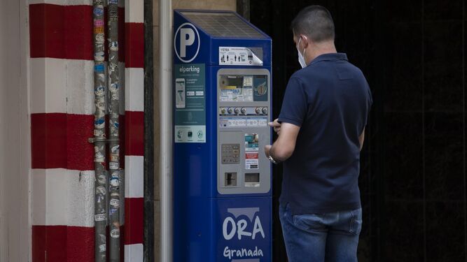 Un conductor paga la ORA en una calle del centro de Granada
