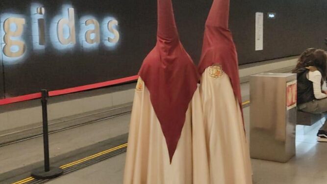 Dos cofrades esperan al Metro en Recogidas